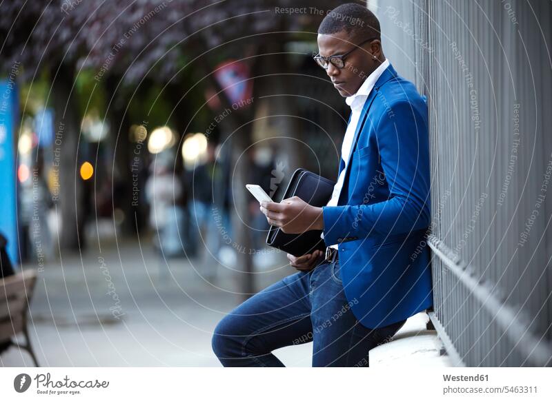 Young businessman wearing blue suit jacket and using smartphone business life business world business person businesspeople Business man Business men