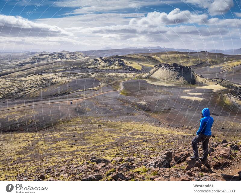 Male tourist admiring landscape while standing on rock, Lakagigar, Iceland color image colour image outdoors location shots outdoor shot outdoor shots day
