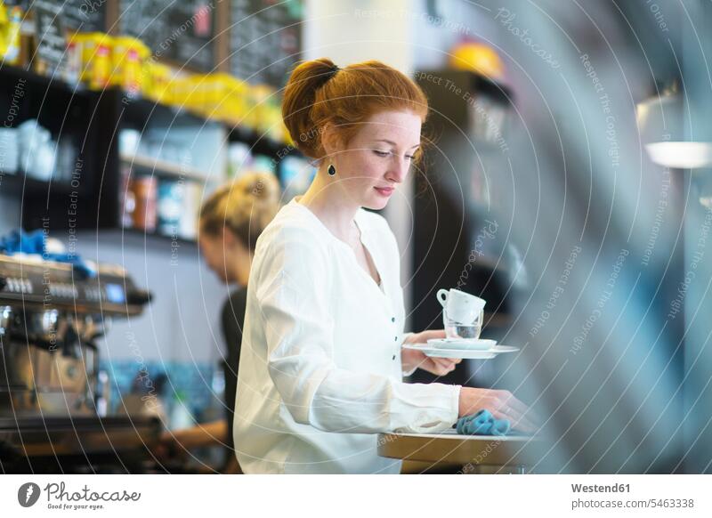 Young woman working in coffee shop human human being human beings humans person persons caucasian appearance caucasian ethnicity european 1 one person only