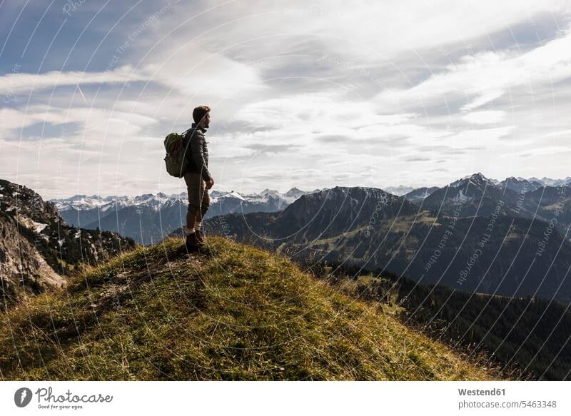 Austria, Tyrol, young man standing in mountainscape looking at view View Vista Look-Out outlook men males hiking hike mountain range mountain ranges