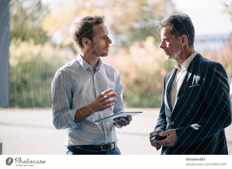 Two businessmen talking at the window human human being human beings humans person persons caucasian appearance caucasian ethnicity european 2 2 people