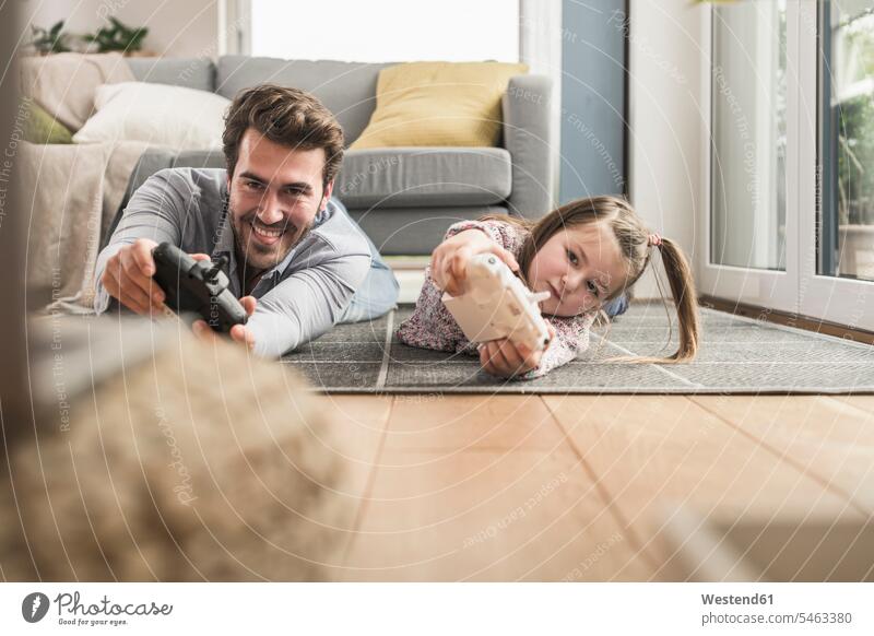 Young man and little girl playing computer game with gaming console Competition competitive single parent hand control hand operation manual control games