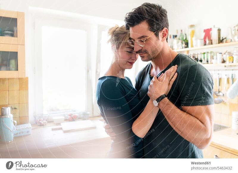Affectionate couple dancing in kitchen at home human human being human beings humans person persons adult grown-up grown-ups grownup grownups mid adult 30 to 40
