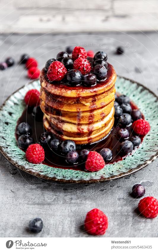 Pancakes with blueberries, raspberries and black currant sirup Plate dish dishes Plates fruit garnished ready to eat ready-to-eat blueberry bilberry bilberries
