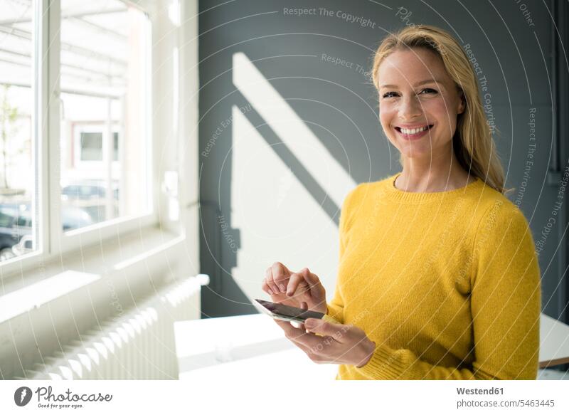 Woman in yellow pullover, using smartphone human human being human beings humans person persons caucasian appearance caucasian ethnicity european 1