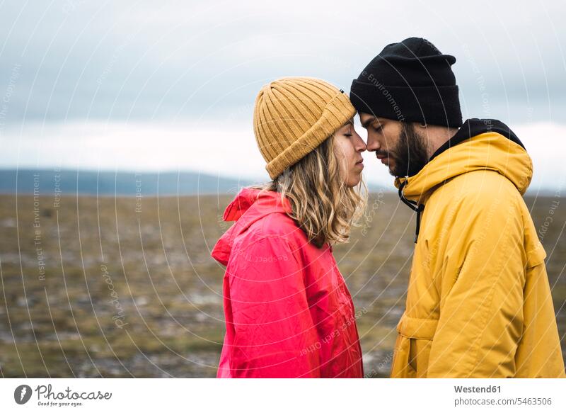 Young couple rubbing affectionately noses, Lapland, Norway North Cape tender loving caressing rubbing nose eskimo kiss rubbing noses young couple young couples