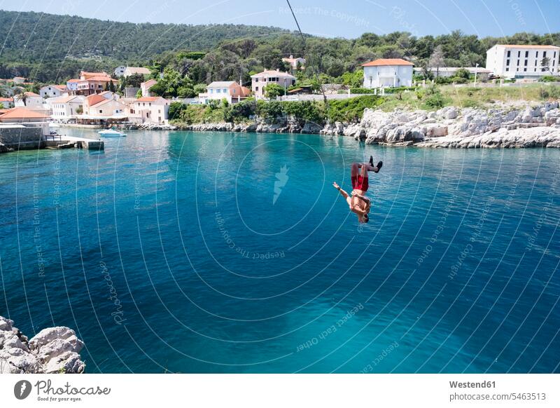 Croatia, Istria, Losinj, Rovenska, Young man bungee jumping tourist tourists Travel destination Destination Travel destinations Destinations Adriatic Sea sea