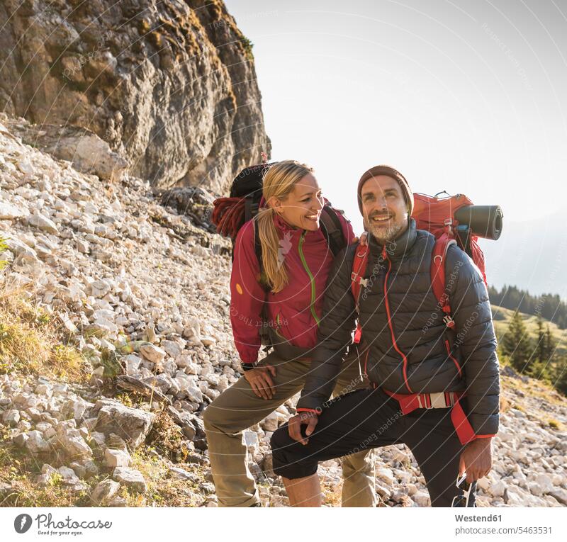 Hiking couple admiring beautiful nature backpack rucksacks backpacks back-packs fascinated fascination mesmerized amazement amazed mountaineering impressed