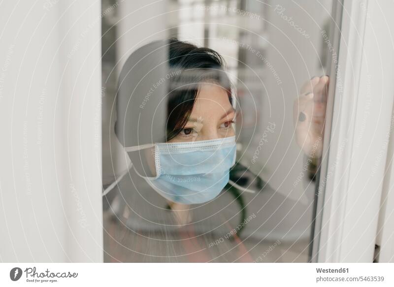 Portrait of with protective mask at window pane human human being human beings humans person persons 1 one person only only one person adult grown-up grown-ups