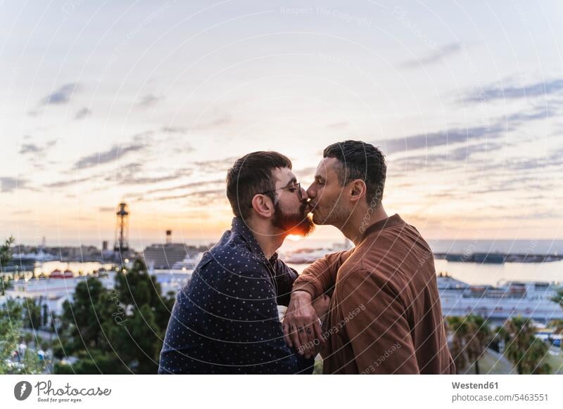 Gay couple kissing on lookout above the city with view to the port, Barcelona, Spain human human being human beings humans person persons caucasian appearance