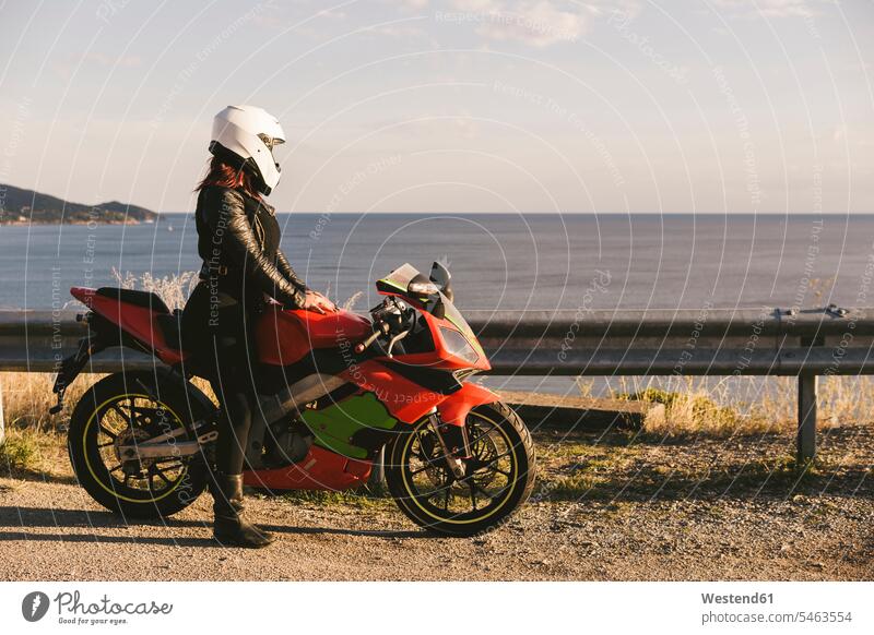 Italy, Elba Island, female motorcyclist at viewpoint motorbike Motor Cycle observation point lookout point Looking At View Looking at a view Gritty Women