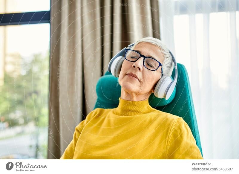 Senior woman sleeping in armchair with headphones on human human being human beings humans person persons caucasian appearance caucasian ethnicity european