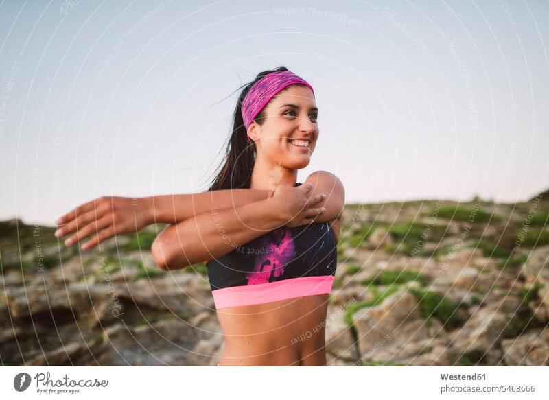Sportive woman stretching arm, shoulder portrait portraits arms smiling smile sportive sporting sporty athletic females women people persons human being humans