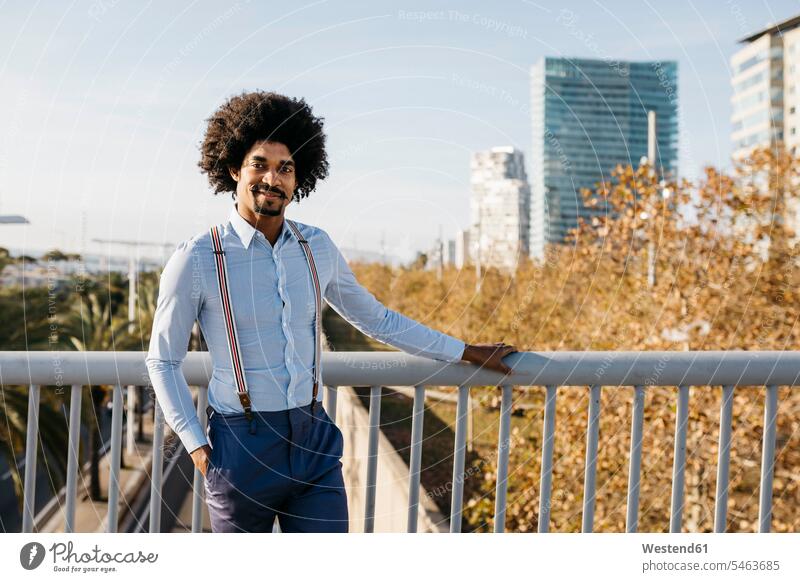 Spain, Barcelona, portrait of smiling man standing on a bridge bridges smile men males Adults grown-ups grownups adult people persons human being humans