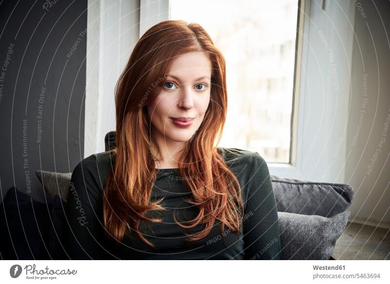 Portrait of redheaded woman in front of window at home portrait portraits red hair red hairs red-haired windows females women people persons human being humans