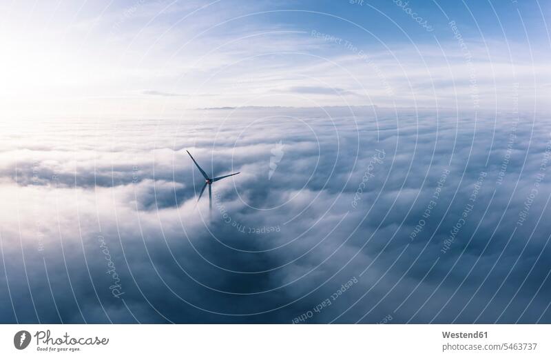 Germany, Aerial view of wind turbine shrouded in clouds at dawn outdoors location shots outdoor shot outdoor shots aerial view bird's eye view bird's eye views