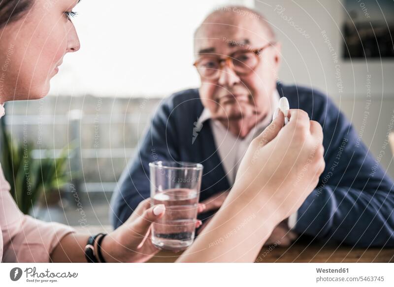 Woman holding pill and glass of water for senior man Water senior men elder man elder men senior citizen tablet woman females women Drink beverages Drinks