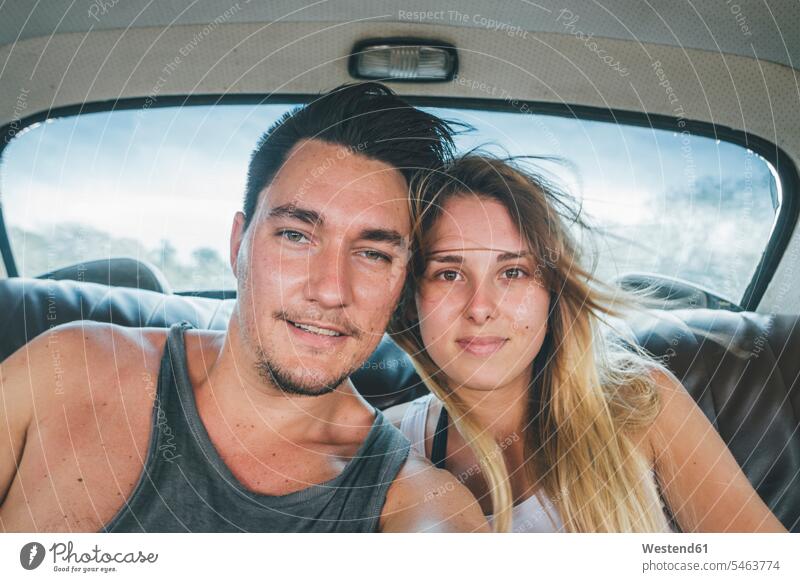Cuba, Yound couple sitting in a vintage car, taking a selfie Selfie Selfies on the move on the way on the go on the road photographing automobile Auto cars