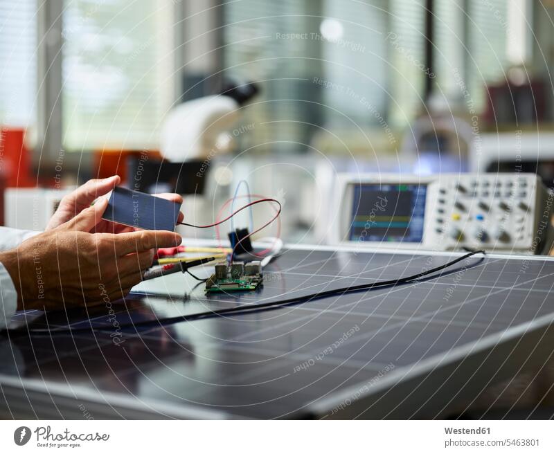 Technician holding silicon solar cell on solar panel human human being human beings humans person persons caucasian appearance caucasian ethnicity european 1