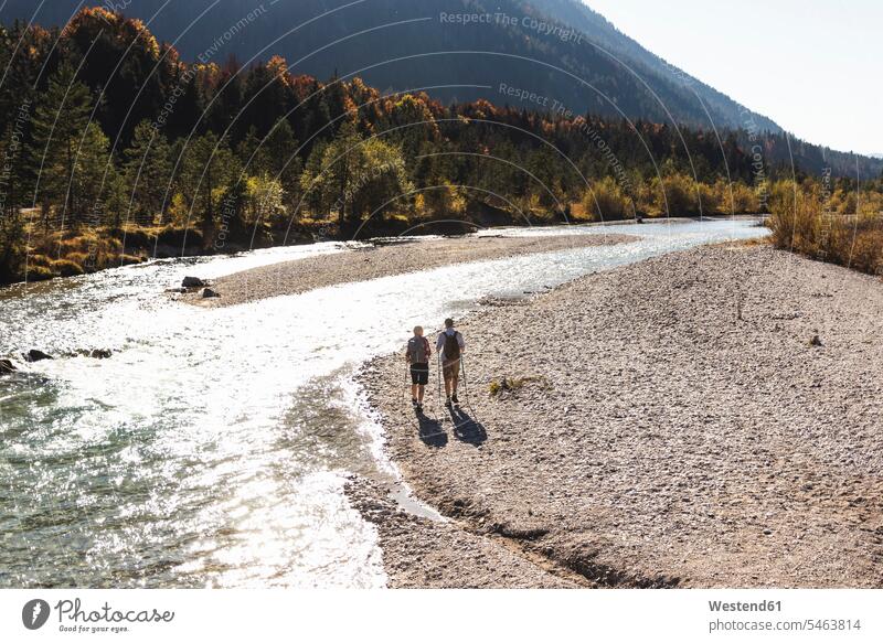 Austria, Alps, couple on a hiking trip walking along a brook caucasian caucasian appearance caucasian ethnicity european White - Caucasian mature men mature man