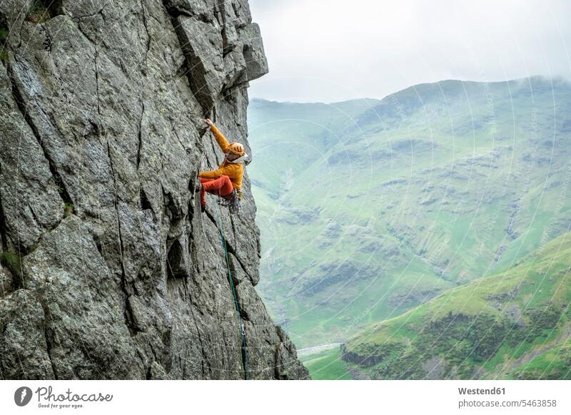 United Kingdom, Lake District, Langdale Valley, Gimmer Crag, climber on rock face climbing rock climber rock wall escarpment Risk risky rocks one person 1