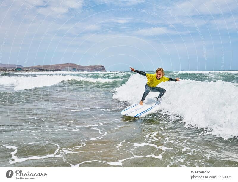 Chile, Arica, boy surfing in the sea Sea ocean surf riding surf ride Surfboarding boys males water water sports Water Sport aquatics child children kid kids