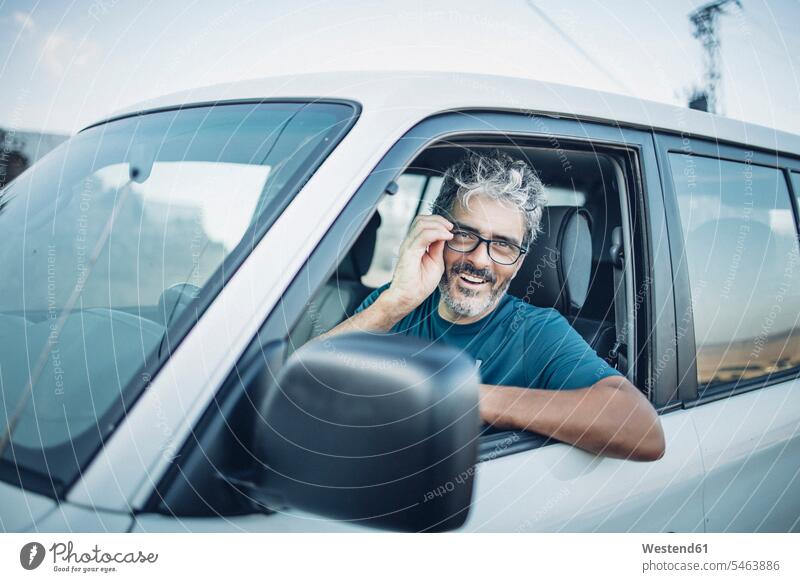 Smiling mature man sitting in his off-road vehicle human human being human beings humans person persons caucasian appearance caucasian ethnicity european 1