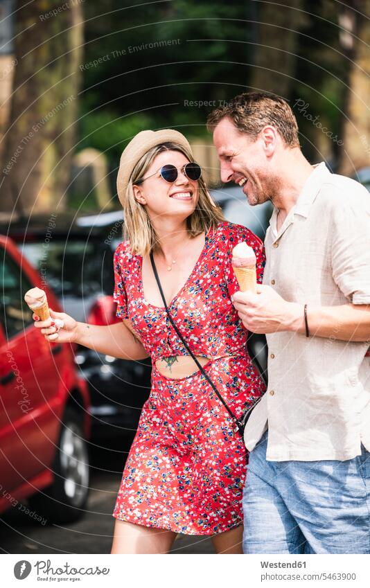 Happy couple with ice cream cones walking in the city Ice Cream Cone ice-cream cone Ice Cream Cones ice-cream wafer icecream Ice Creams happiness happy town