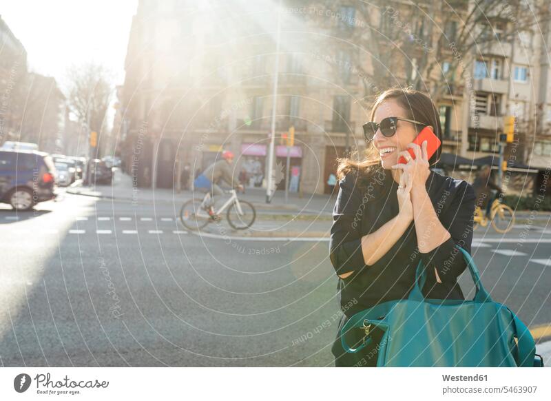 Elegant woman talking on cell phone in the city elegant chic elegance stylishly classy town cities towns mobile phone mobiles mobile phones Cellphone