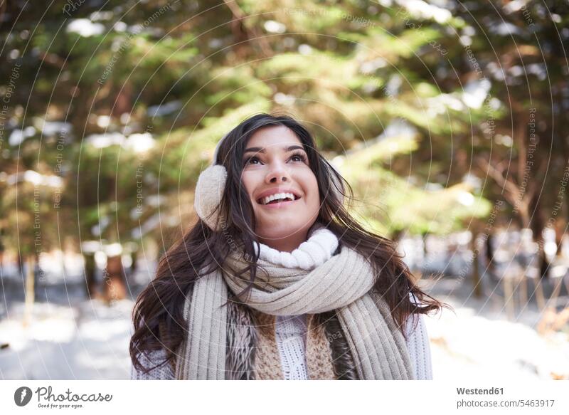 Portrait of happy young woman in winter forest females women woods forests hibernal portrait portraits happiness Adults grown-ups grownups adult people persons