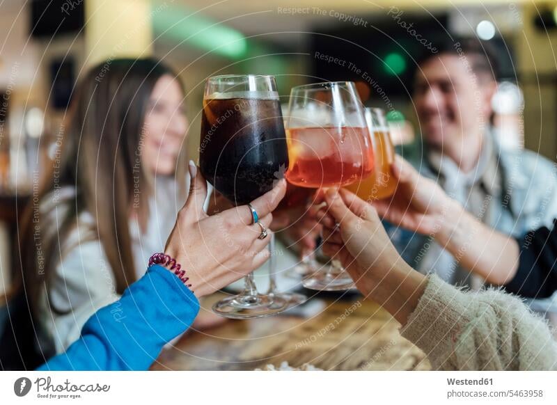 Friends toasting drink over table in bar color image colour image indoors indoor shot indoor shots interior interior view Interiors 16-17 years 16 to 17 years