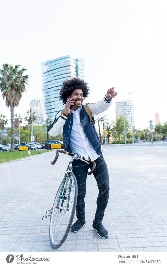 Happy casual businessman with bicycle on cell phone in the city, Barcelona, Spain business life business world business person businesspeople Business man