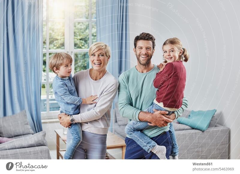 Portrait of happy family with two kids at home families portrait portraits child children happiness people persons human being humans human beings leisure