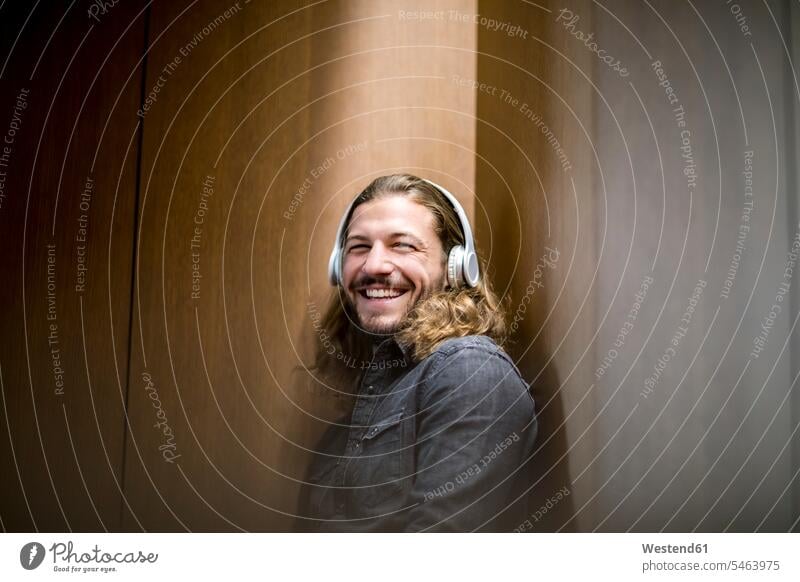 Portrait of laughing man listening music with headphones hearing Laughter headset portrait portraits positive Emotion Feeling Feelings Sentiments Emotions