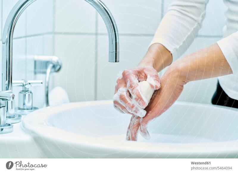 Woman washing her hand with soap indoor interior shot indoors interiour photo interiour photos interiour shots Contemporary detail close-up close-ups closeup