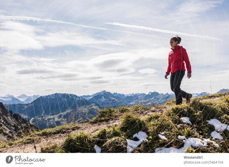 Austria, Tyrol, young woman hiking in the mountains females women mountain range mountain ranges hike Adults grown-ups grownups adult people persons human being