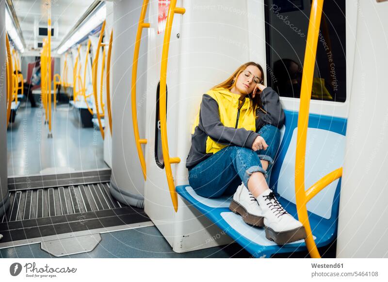 Young woman sleeping in underground train touristic tourists transport railroad railroads Railways subway subway line subway lines subway train subway trains