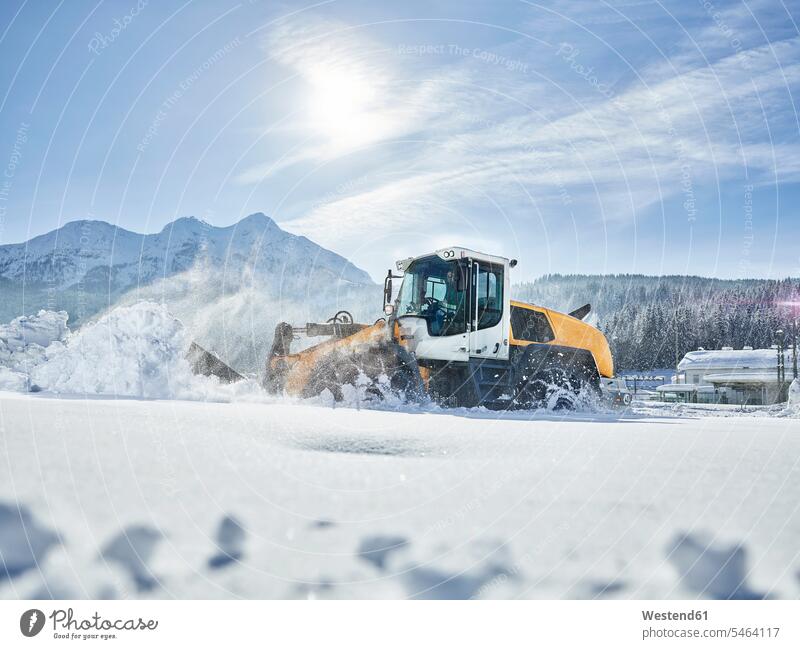 Austria, Tyrol, Hochfilzen, snow-plowing service, snow clearance with wheel loader mature men mature man mountain mountains outdoors outdoor shots location shot