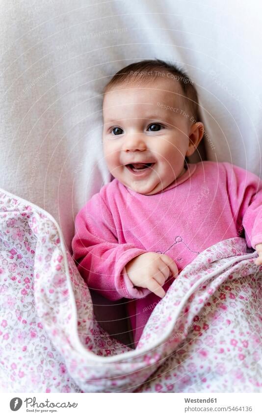 Portrait of happy baby girl in pink pyjama lying on bed human human being human beings humans person persons caucasian appearance caucasian ethnicity european 1