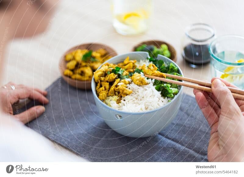 Curry chicken, broccoli and rice, woman with chopsticks Chicken Curry Rice tasting taste holding Food foods food and drink Nutrition Alimentation