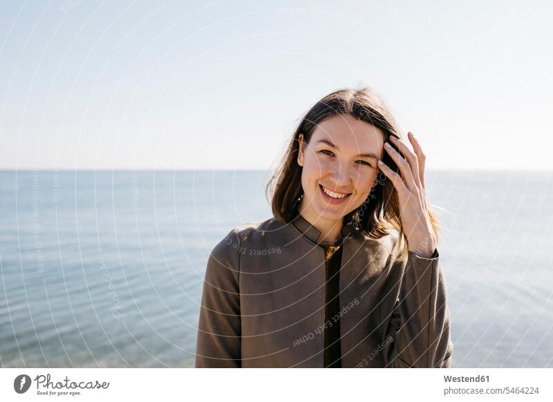 Portrait of smiling woman with the sea in background smile ocean portrait portraits females women water waters body of water Adults grown-ups grownups adult