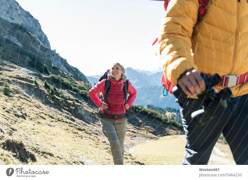 Austria, Tyrol, smiling woman with man hiking in the mountains mountain range mountain ranges couple twosomes partnership couples females women smile hike