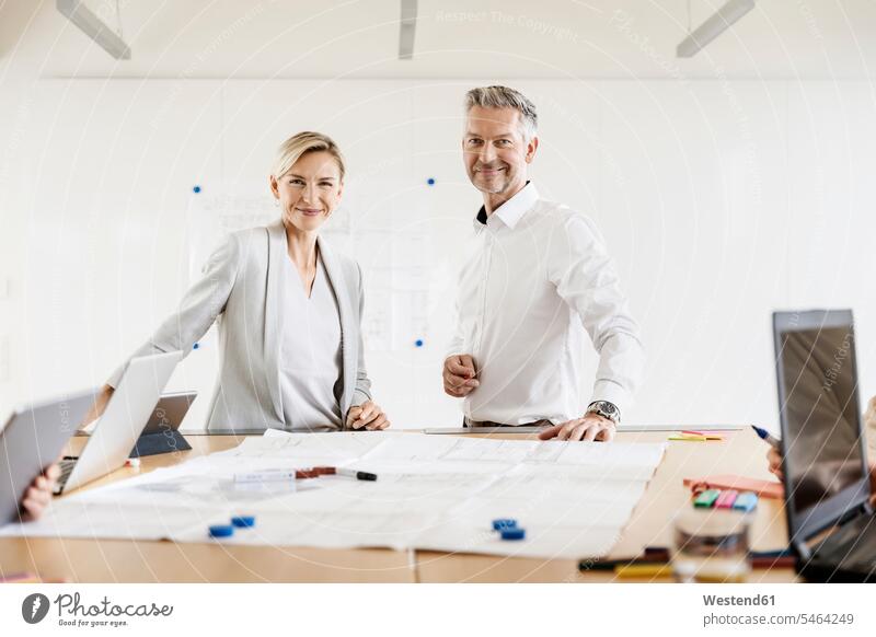 Portrait of confident businesswoman and businessman leading a meeting in office human human being human beings humans person persons caucasian appearance
