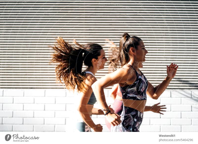 Three sporty young women running in the city human human being human beings humans person persons caucasian appearance caucasian ethnicity european Group