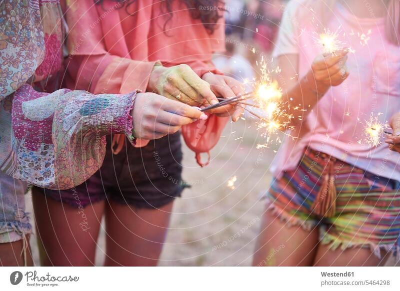 Women having fun with sparklers at music festival Sparkler female friends Fun funny music festivals celebrating celebrate partying holding mate friendship