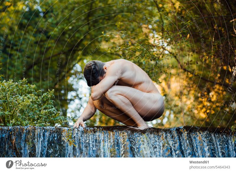 Nude young man on a waterfall human human being human beings humans person persons caucasian appearance caucasian ethnicity european 1 one person only