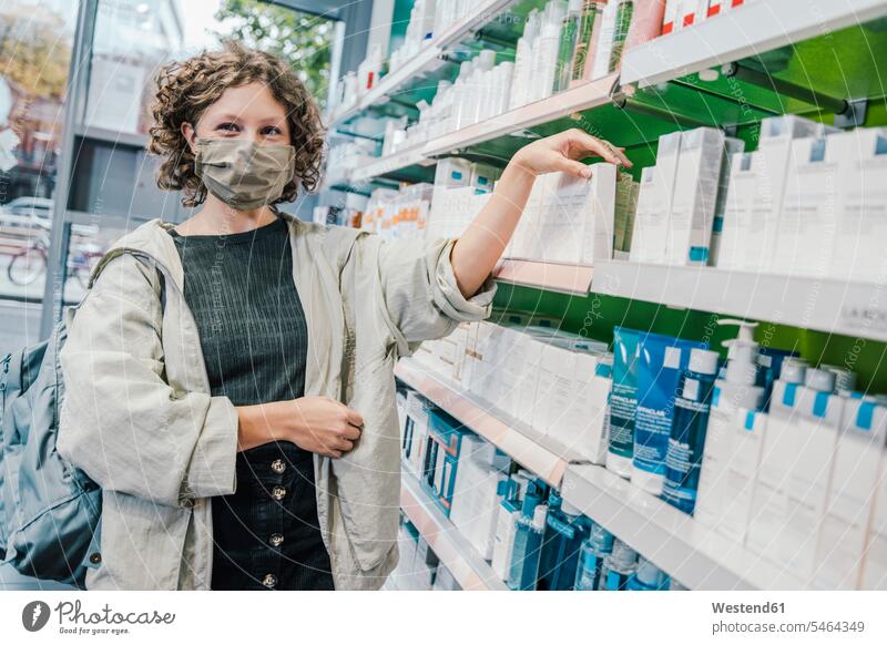 Female customer wearing protective face mask in chemist shop color image colour image indoors indoor shot indoor shots interior interior view Interiors Germany