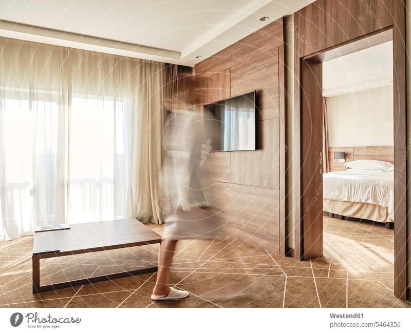 Blurred image of woman walking in luxury hotel room color image colour image indoors indoor shot indoor shots interior interior view Interiors day daylight shot