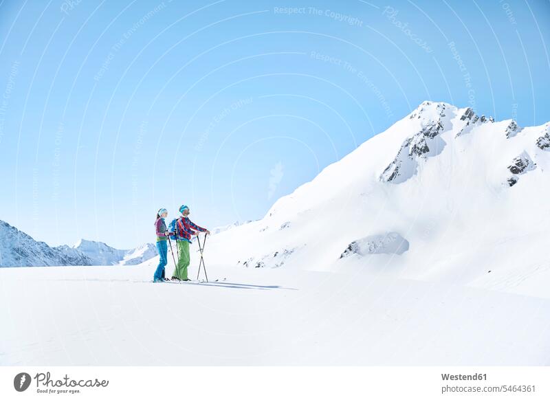 Couple of ski tourers having a break in the mountains, Kuehtai, Tyrol, Austria hibernal stand sports Winter Sports wintersports free time leisure time on the go