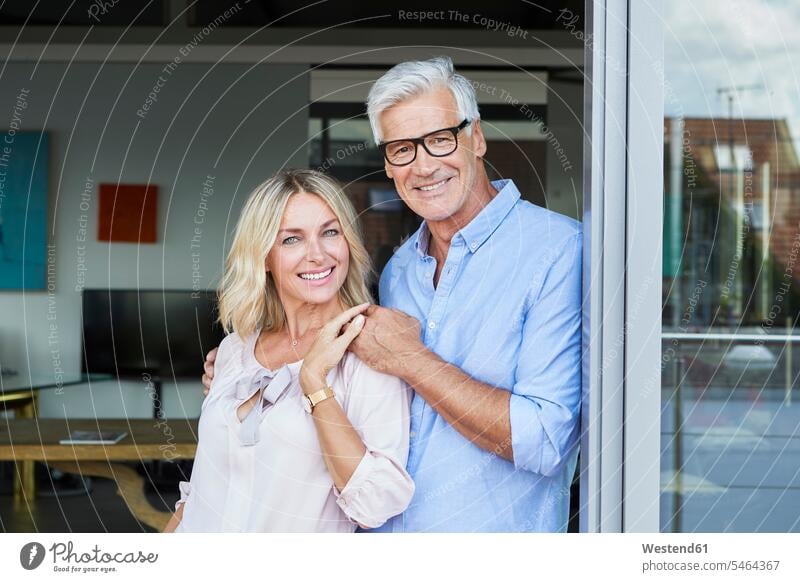 Portrait of smiling mature couple at the balcony at home smile balconies standing twosomes partnership couples portrait portraits people persons human being
